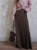 Coffee brown long a-line skirt with asymmetrical side seam and flared hem.