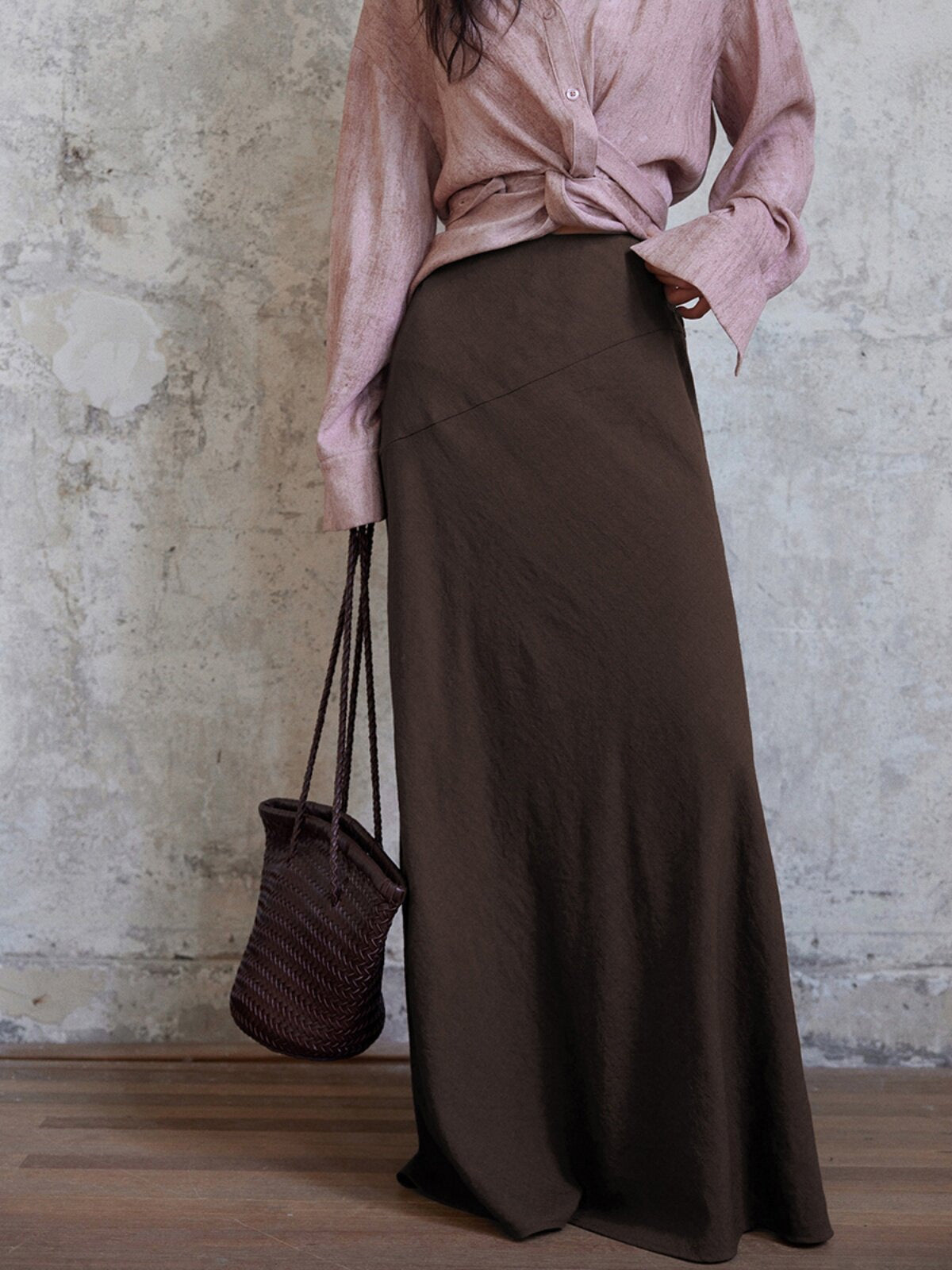 Coffee brown long a-line skirt with asymmetrical side seam and flared hem.