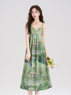 Green floral midi dress with thin straps and embellished waistband.