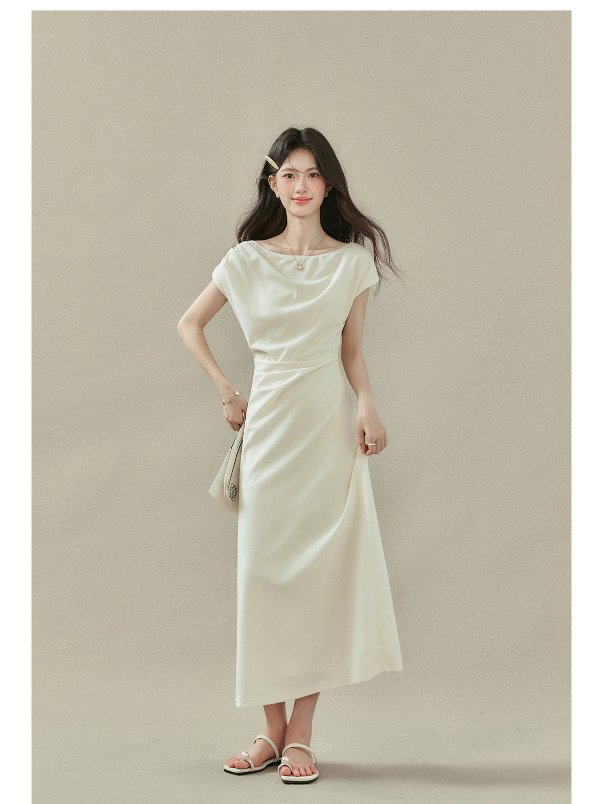 Cream off-shoulder dress with short sleeves and side slit, draped fabric at neckline and waist.