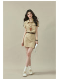 Beige short-sleeve shirt dress with collar, button placket, and two chest pockets.