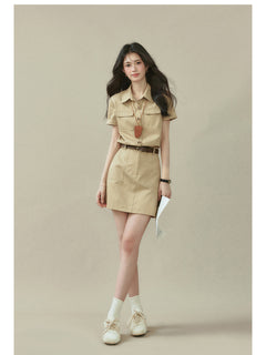 Beige short-sleeve shirt dress with collar, button placket, and two chest pockets.