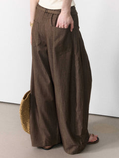 Brown wide-leg pants with pleats and a tie belt