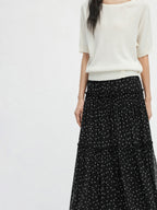 Black floral A-line skirt with tiered sheer hem and gathered waist