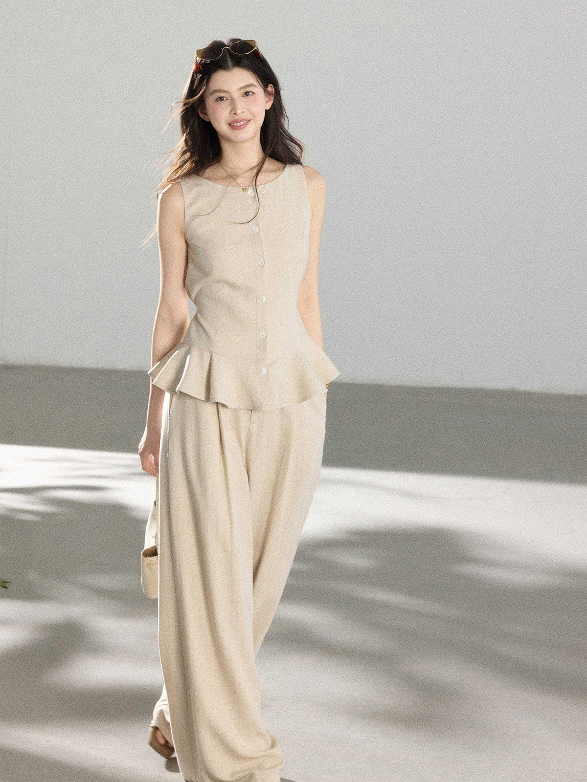 Beige wide-leg pants with front pleats and high-rise waist
