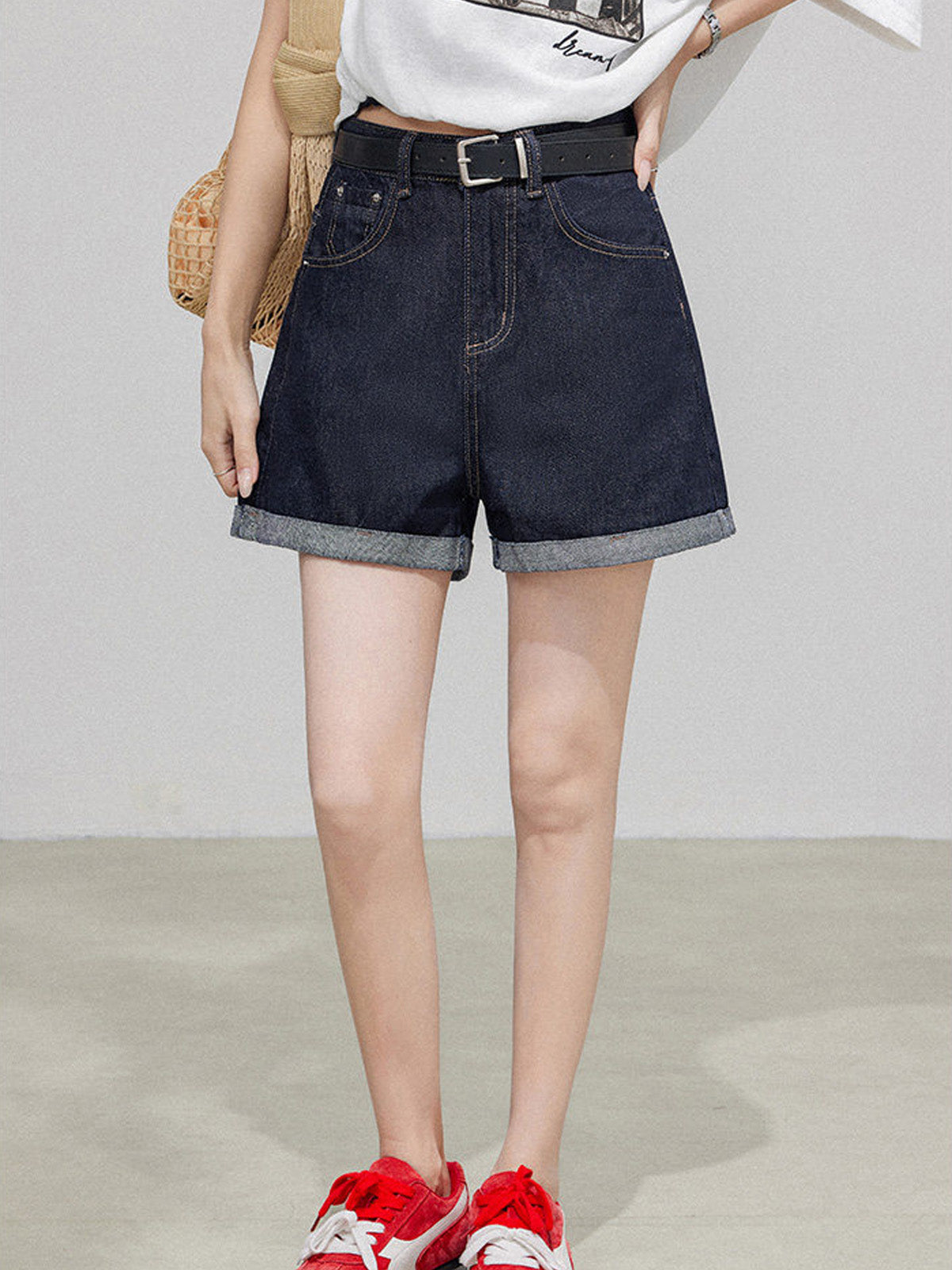 Dark blue high rise denim shorts with cuffed hem and front pockets.
