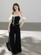 Black off-shoulder ruffled top with polka dot fabric straps.