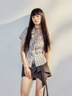 Grey purple striped blouse with ruffle trim and front tie detail.