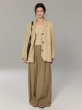 Beige long double-breasted blazer with notch collar and three-button cuffs.
