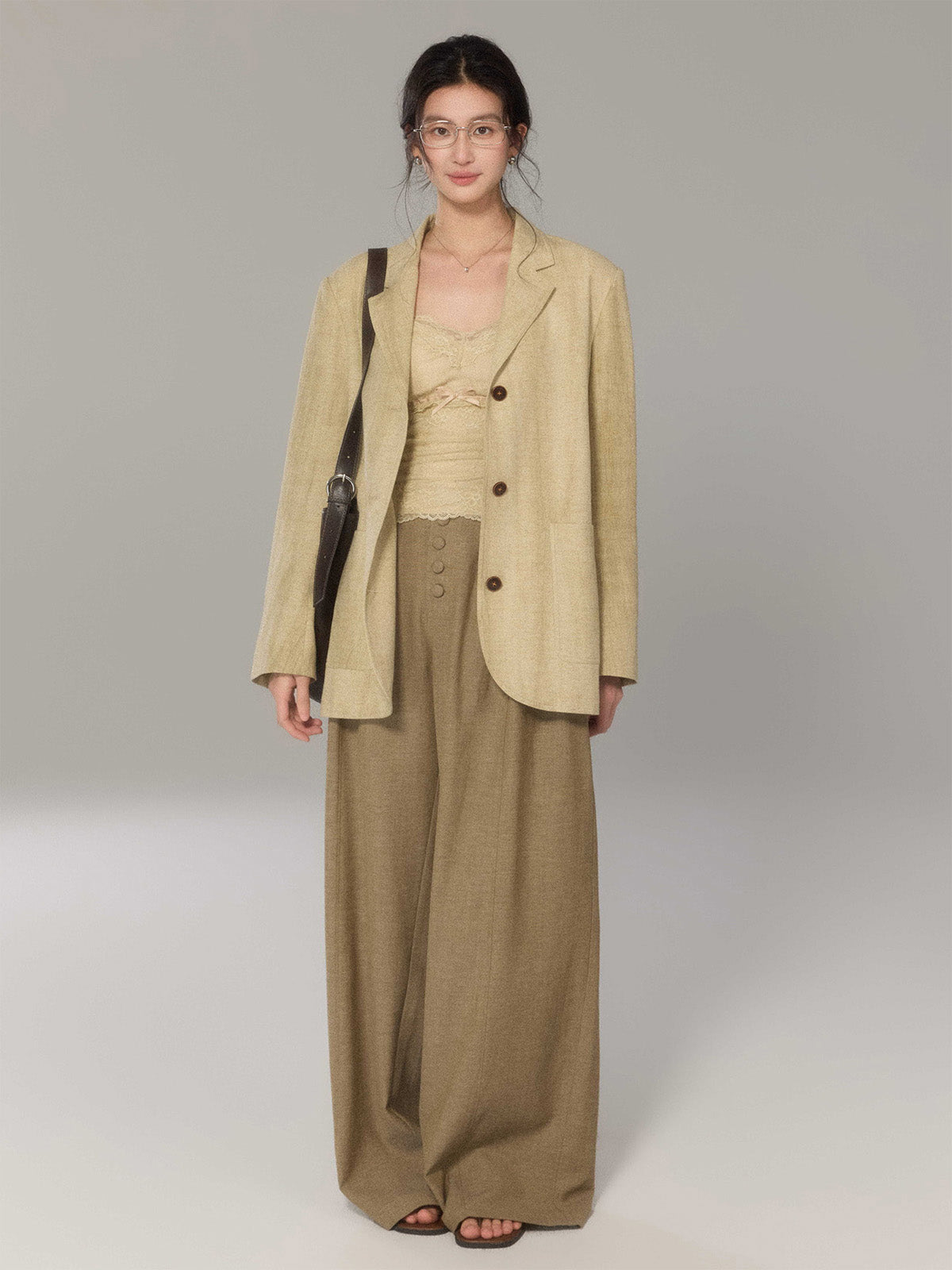 Beige long double-breasted blazer with notch collar and three-button cuffs.
