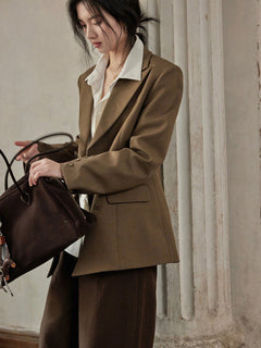 Brown long double-breasted blazer with notched lapels and buttoned cuffs.