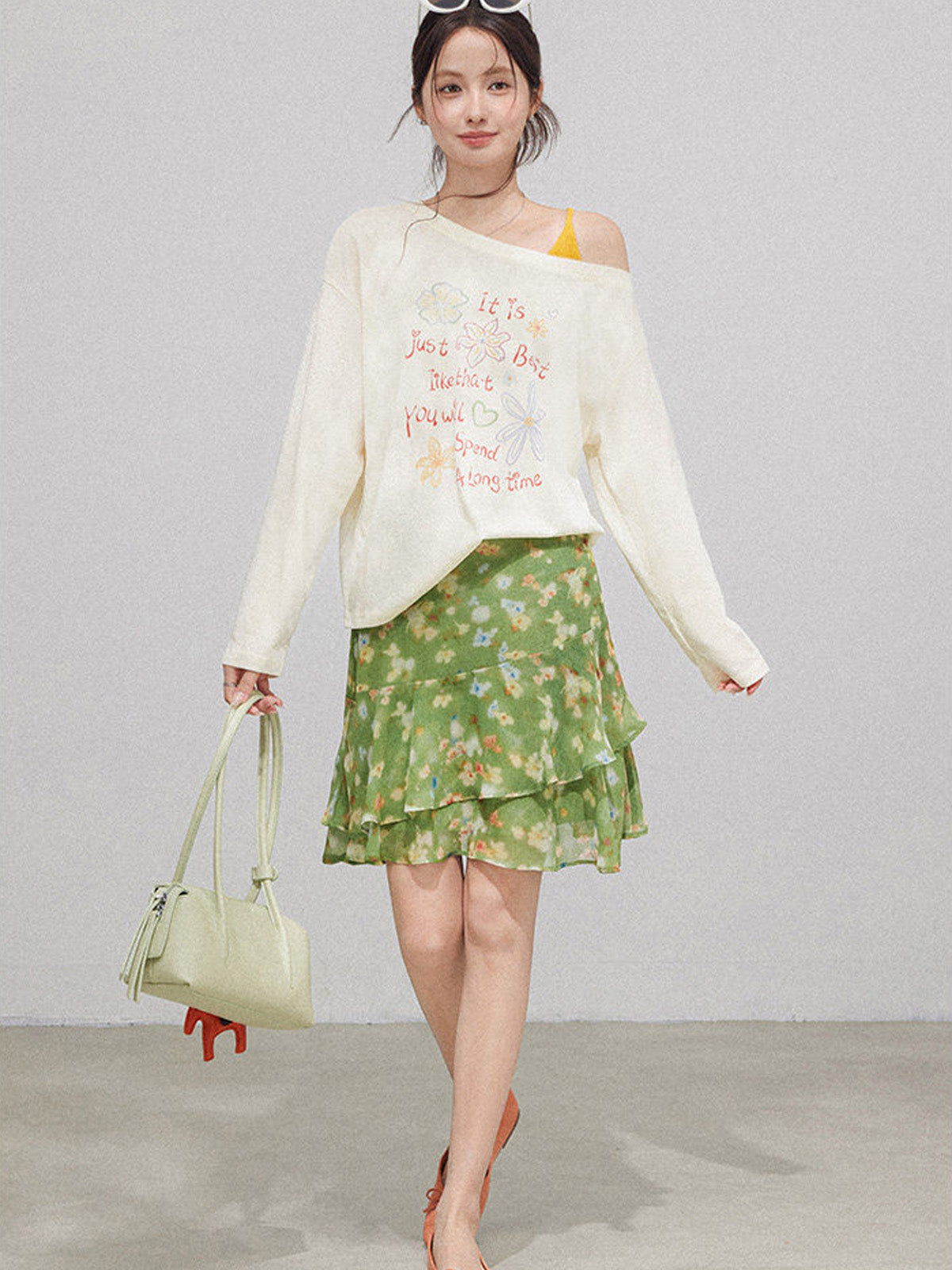 Green floral high waist skirt with layered ruffles and ruffled hem.