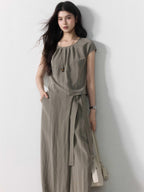 Taupe grey wide-leg pants with tie belt and side pockets, full-length view.