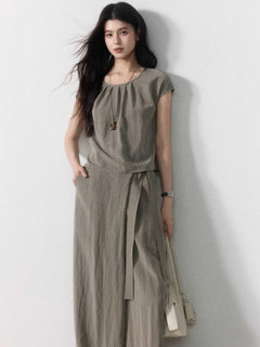 Taupe grey wide-leg pants with tie belt and side pockets, full-length view.
