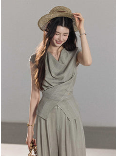 Light grey wide-leg pants with vertical stripes and a tied waist belt.