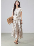 Beige paisley a-line midi skirt with tiered construction and flared hem.
