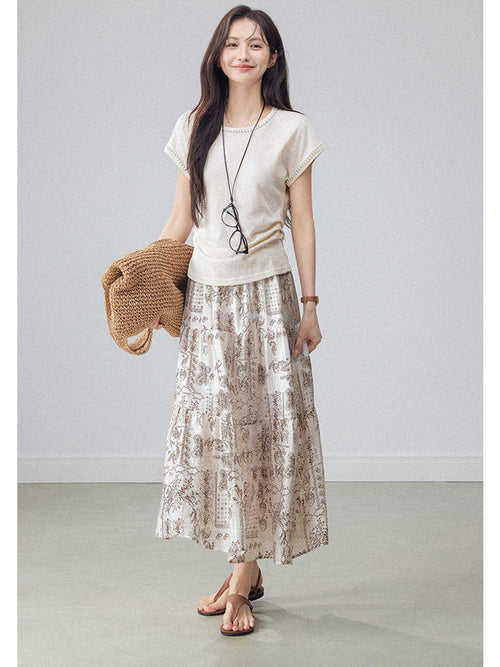 Beige paisley a-line midi skirt with tiered construction and flared hem.