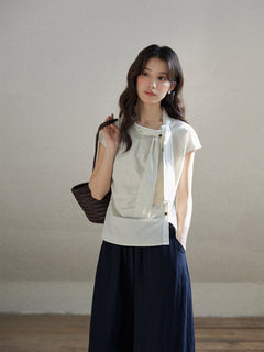 Ivory stripe short sleeve blouse with asymmetrical tie detail and button closure.