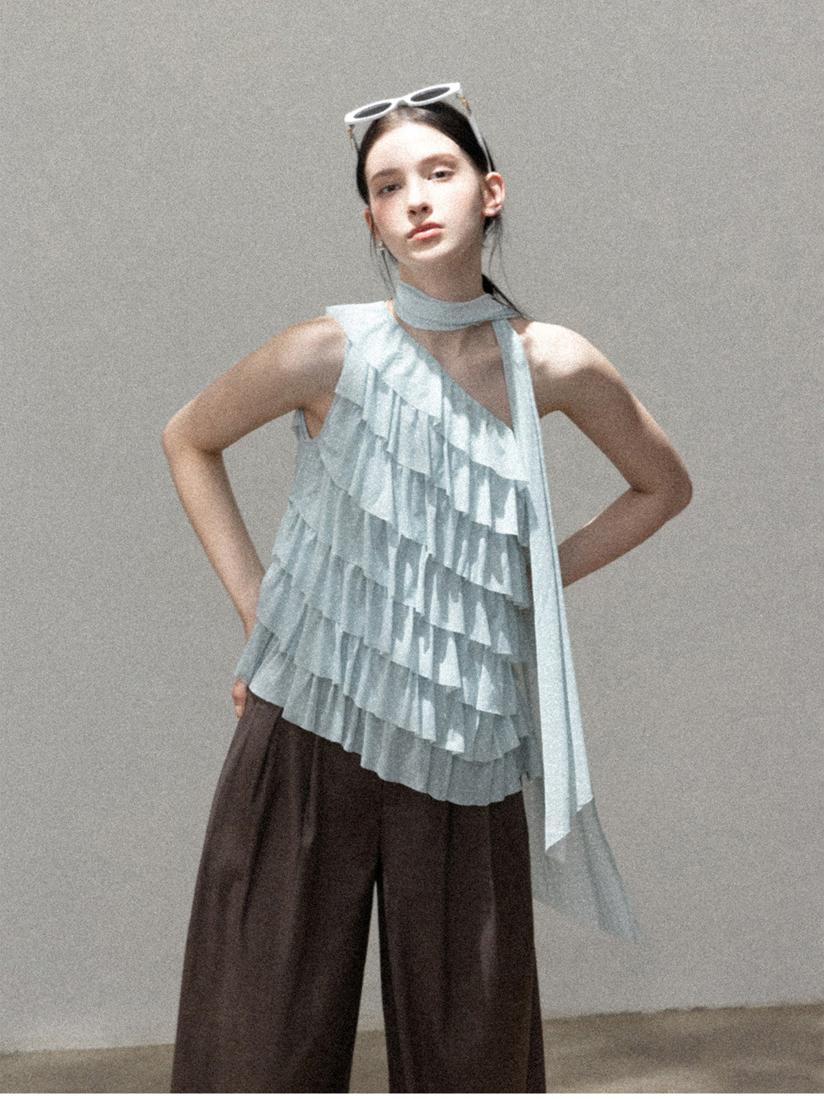 Light blue asymmetric halter top with layered ruffles and open back