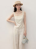 Ivory short a-line tank top with square neck and open back.