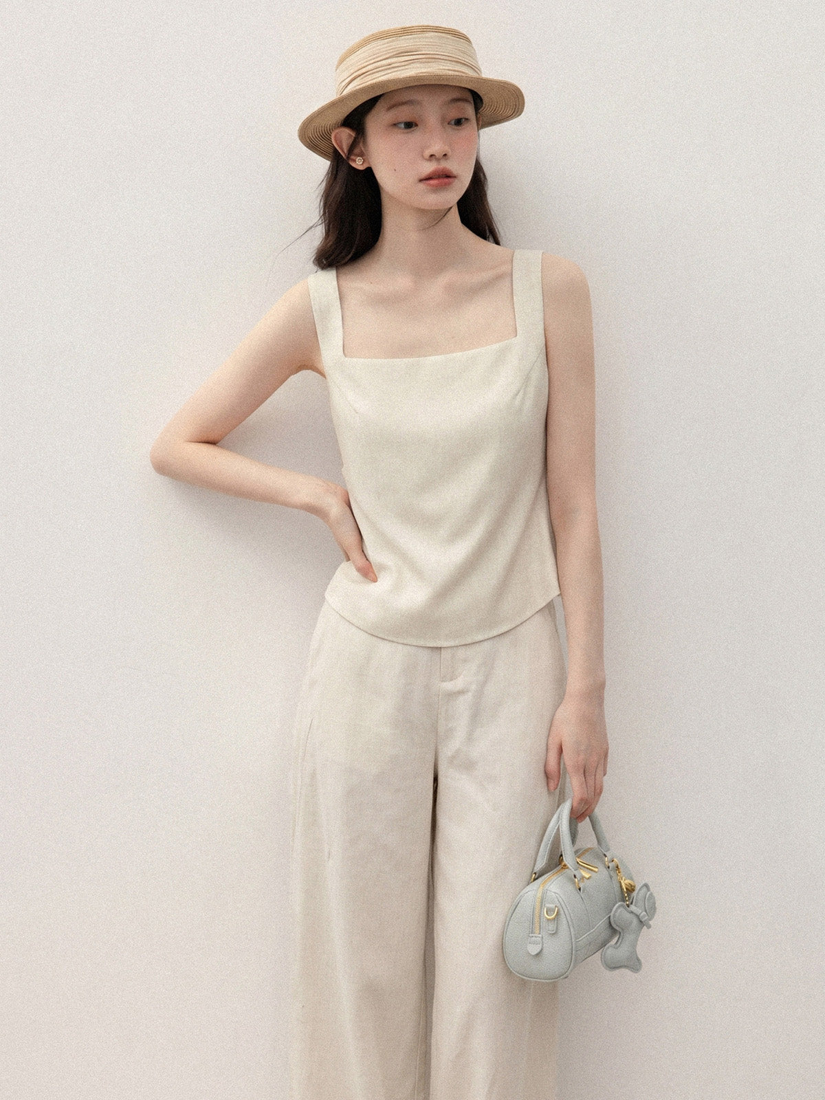Ivory short a-line tank top with square neck and open back.