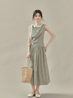 Black and white checkered A-line midi dress with lace trim neckline and white bow tie strap.
