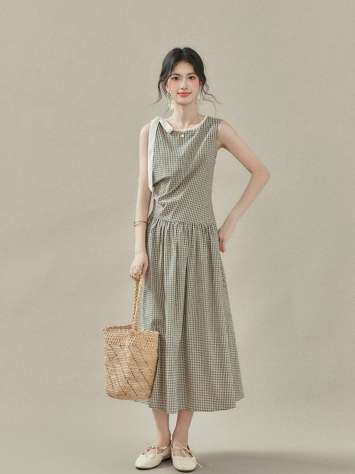 Black and white checkered A-line midi dress with lace trim neckline and white bow tie strap.