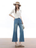 High rise light blue flared jeans with scalloped hem and embroidered stars.