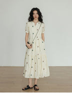 Ivory A-line dress with mandarin collar and floral embroidery.
