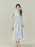Light blue midi dress with vertical stripes, a bow tie neckline, lace trim on the shoulders and hem, and a gathered waist.