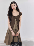 Brown puff sleeve top with ruched bust and lace trim.