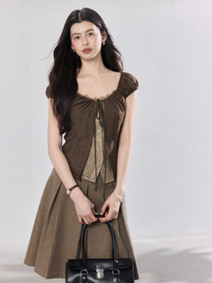 Brown puff sleeve top with ruched bust and lace trim.