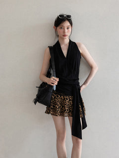 Black halter top with V-neck and asymmetric hem, front view