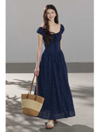 Navy blue dress with square neckline, puffed sleeves, and A-line silhouette