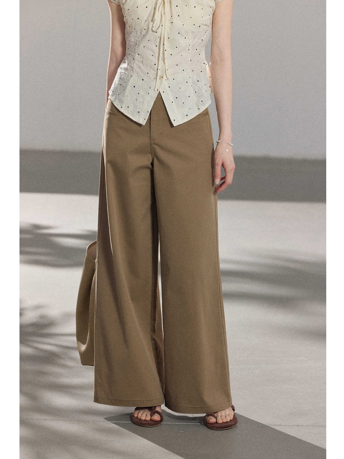 Close-up of khaki wide-leg pants showing straight hem and side seam