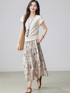 Layered beige paisley skirt featuring an elastic waistband and flared hem.