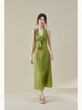 Green floral dress featuring a ruffled detail at the halter neck.