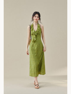 Green floral dress featuring a ruffled detail at the halter neck.