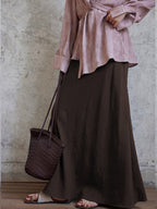 Brown A-line skirt featuring an asymmetrical side seam detail.
