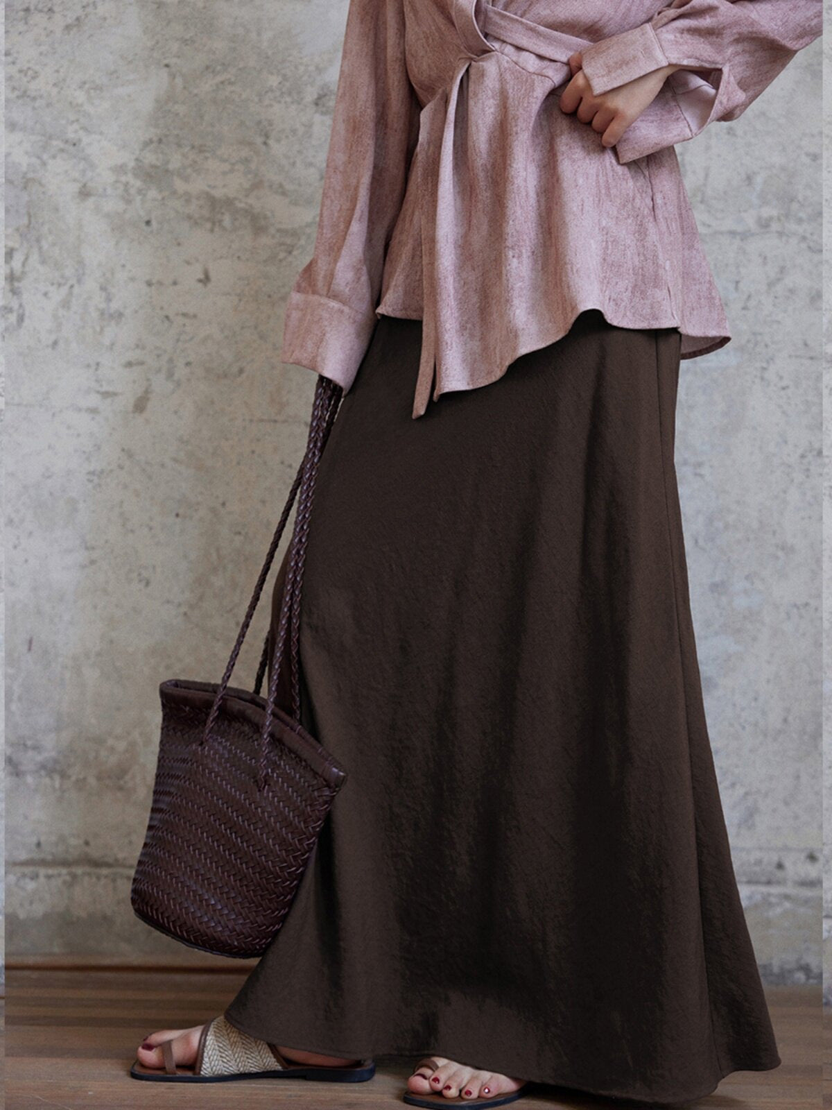 Brown A-line skirt featuring an asymmetrical side seam detail.