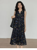 Sleeveless black dress with button-front closure and floral print
