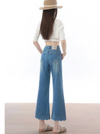 Back view of high rise light blue flared jeans with back waistband label.