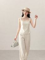 Front view of ivory sleeveless tank top with square neckline.
