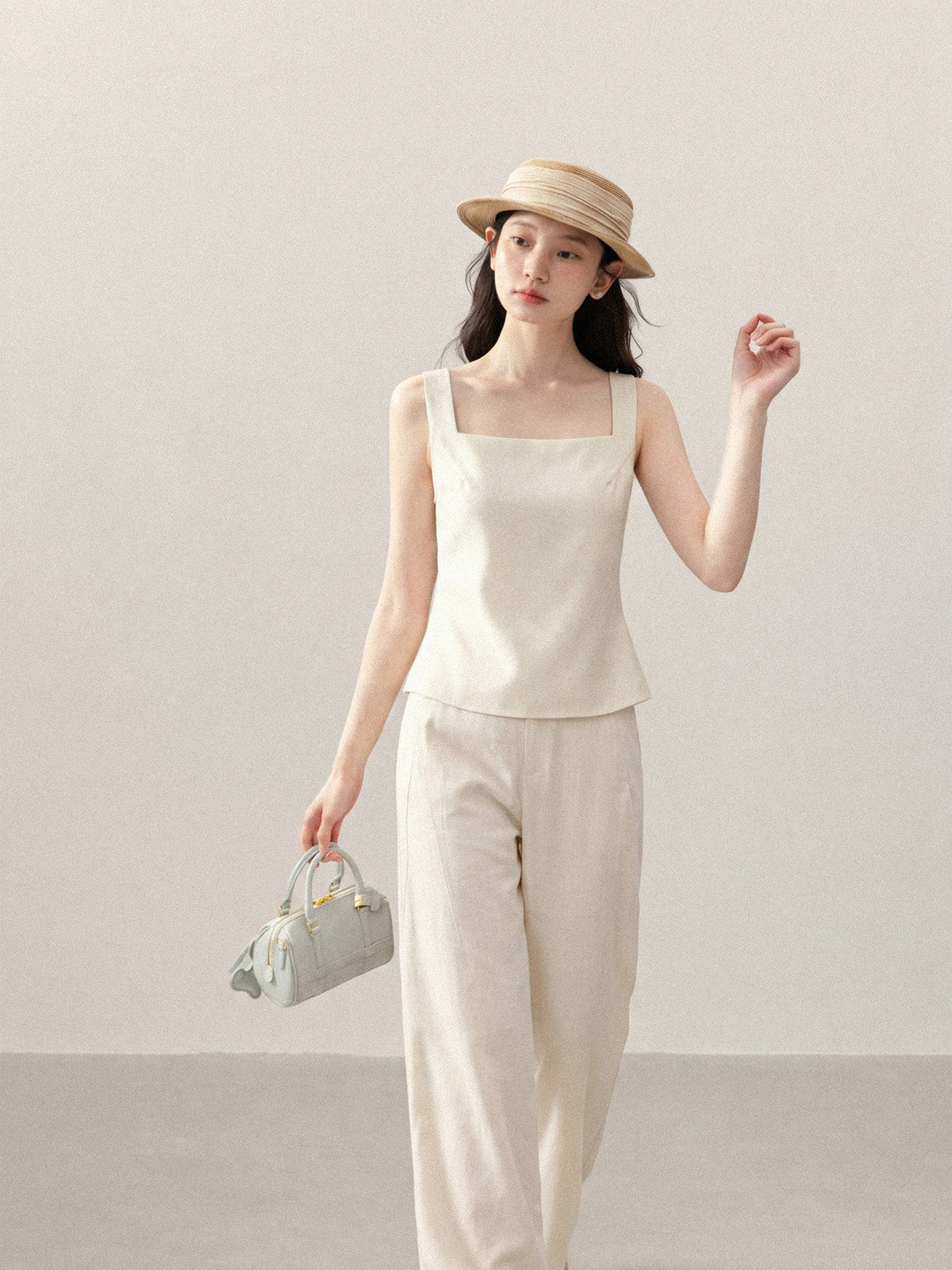 Front view of ivory sleeveless tank top with square neckline.