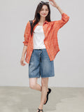 Denim shorts featuring a button and zip fly closure.