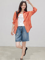 Denim shorts featuring a button and zip fly closure.