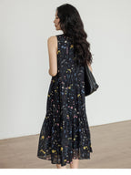Black tiered midi dress featuring a V-neckline and gathered waist
