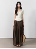 Brown wide-leg pants with an elastic waistband and tie belt