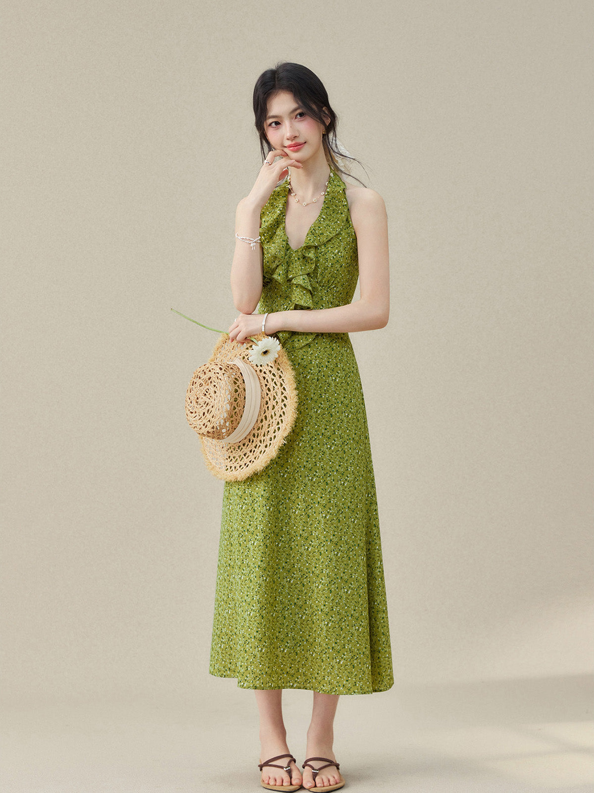 Halter neck dress with small floral print and flared hem.
