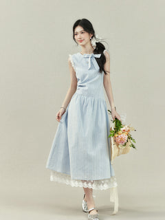 Light blue dress with vertical stripes, lace trim on the shoulders and hem, a bow tie neckline, and a gathered waist.